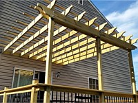 <b>Wood pergola on a wood deck with black aluminum balusters</b>